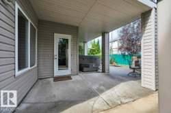 Patio with direct access to the walk-out basement. Covered concrete patio and hot tub - 
