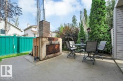 Poured concrete patio featuring an outdoor fireplace. - 