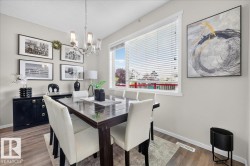 Recessed lighting, wood-finish flooring, and a large window with blinds - 