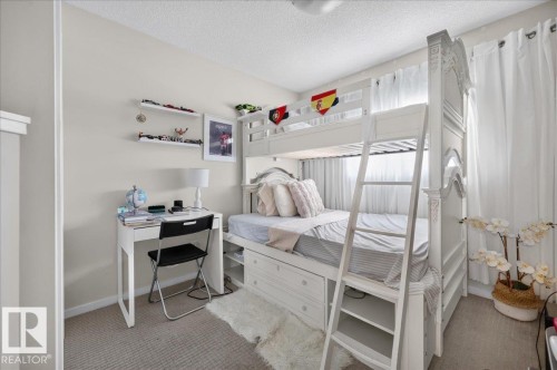 Neutral wall paint, textured carpeting, and white trim - 2046 Chalmers Way Sw, Edmonton, AB 