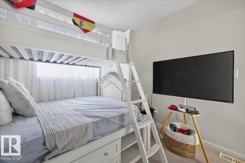 Built-in bunk bed with integrated storage drawers and a ladder access - 2046 Chalmers Way Sw, Edmonton, AB 