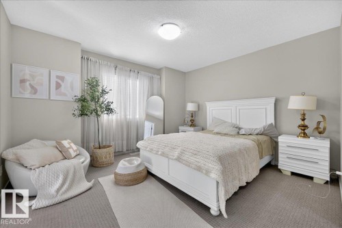 Carpeted flooring, white painted walls, and a window with sheer curtains - 2046 Chalmers Way Sw, Edmonton, AB 