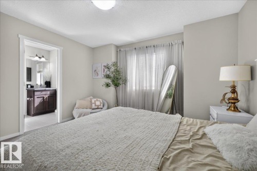 Carpeted bedroom with neutral wall tones and a window with blinds - 2046 Chalmers Way Sw, Edmonton, AB 