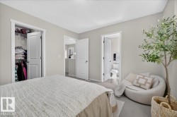 Light-colored walls, carpeted flooring, and a single-panel door with a privacy lock - 