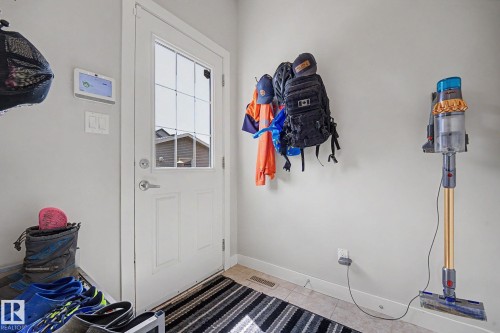 Entryway featuring a white paneled door with a grid-patterned window insert - 3343 Weidle Way Sw, Edmonton, AB 