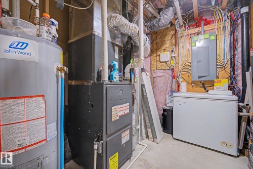Utility room featuring a water heater, furnace, and electrical panel - 3343 Weidle Way Sw, Edmonton, AB 