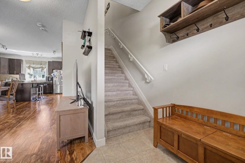 Staircase with carpeted steps and white handrails - 3343 Weidle Way Sw, Edmonton, AB 