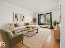 Hardwood flooring throughout, white walls, and a large sliding glass door with black trim - 