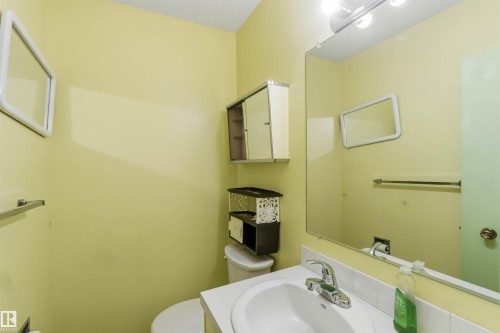 White single-basin vanity with chrome faucet and integrated countertop - 9311 68 Street Nw, Edmonton, AB 