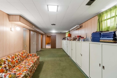 Wood-finish wall paneling, built-in storage cabinetry, fluorescent lighting, and a drop ceiling - 9311 68 Street Nw, Edmonton, AB 