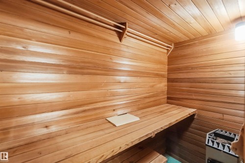 Wood-paneled interior with built-in bench and wall-mounted light fixture - 9311 68 Street Nw, Edmonton, AB 
