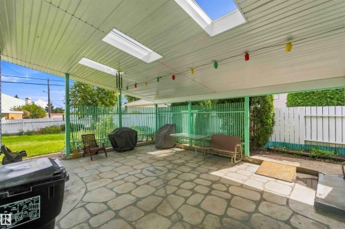 Covered patio featuring an interlocking stone surface and skylights - 9311 68 Street Nw, Edmonton, AB 