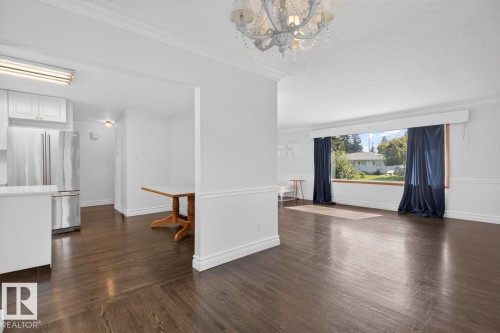 Wood-finish flooring with white trim throughout - 7304 98A Avenue Nw, Edmonton, AB 