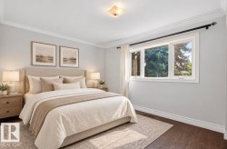 Hardwood flooring, crown molding, double-paned window, neutral wall tones, and ceiling light fixture - 