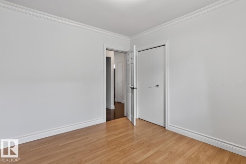Wood-finish flooring, white walls, and a ceiling-mounted light fixture - 7304 98A Avenue Nw, Edmonton, AB 