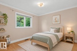 Crown molding, wood-finish flooring, flush mount lighting, and a white framed window - 