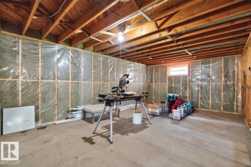 Unfinished basement with exposed wood joists and framed, insulated walls - 7304 98A Avenue Nw, Edmonton, AB 