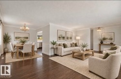 Dark wood-finish flooring, white crown molding, recessed archway, and a multi-arm chandelier in the dining area - 