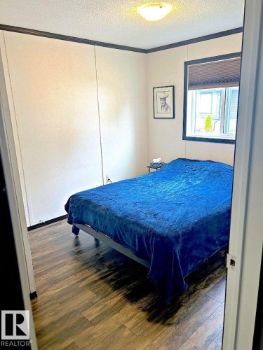 Recessed lighting, wood-finish flooring, and a window with blinds - 63 Willow Park Estates, Leduc, AB 