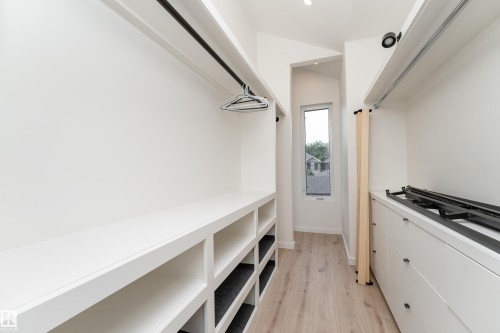 Built-in closet system with open shelving and hanging rods - 10138 90 Street Nw, Edmonton, AB 