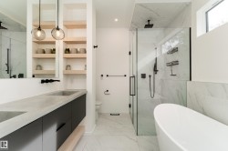 Dual concrete-finish sinks with black cabinetry - 
