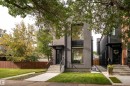 Contemporary exterior, prominent large windows, concrete front steps with metal railings, dark-framed entry door, and a manicured lawn - 10138 90 Street Nw, Edmonton, AB 