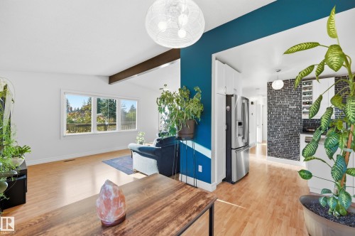 Open-concept living area with vaulted ceilings and wood-finish flooring - 3523 106 Street Nw, Edmonton, AB 