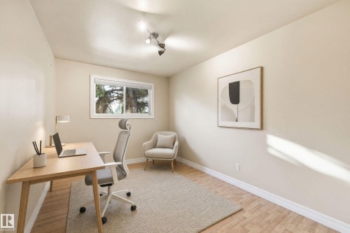 Recessed lighting, wood-finish flooring, and a large window providing natural light - 3523 106 Street Nw, Edmonton, AB 