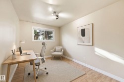 Recessed lighting, wood-finish flooring, and a large window providing natural light - 