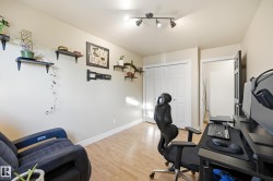 Recessed track lighting, light-toned wood-finish flooring, white bi-fold closet doors, and light-colored wall paint - 
