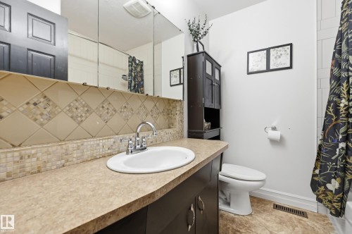 Vanity with an integrated sink, polished chrome faucet, and ample countertop space - 3523 106 Street Nw, Edmonton, AB 