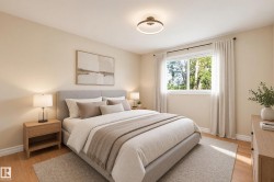 Hardwood-style flooring, large window with ample natural light, neutral wall tones, modern ceiling light fixture, and white trim - 