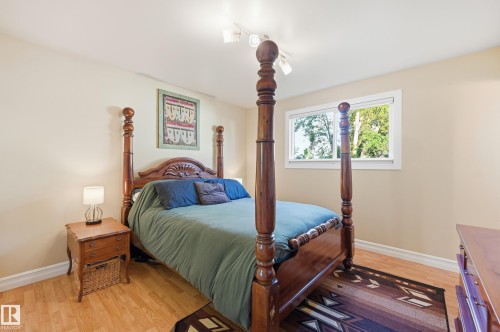 Wood-finish flooring, neutral wall tones, and a white-framed window - 3523 106 Street Nw, Edmonton, AB 