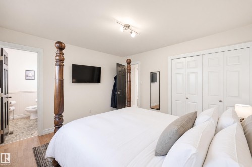 Wood-finish flooring, white walls, double-panel closet doors, and recessed track lighting - 3523 106 Street Nw, Edmonton, AB 