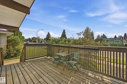 Expansive outdoor deck with wood-finish flooring and slatted railings - 3523 106 Street Nw, Edmonton, AB 