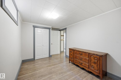 Wood-finish flooring, white walls, and a white ceiling with recessed lighting - 3523 106 Street Nw, Edmonton, AB 