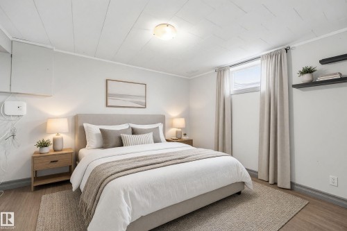 Panel ceiling with central flush mount lighting, wood-finish flooring, and built-in shelving - 3523 106 Street Nw, Edmonton, AB 