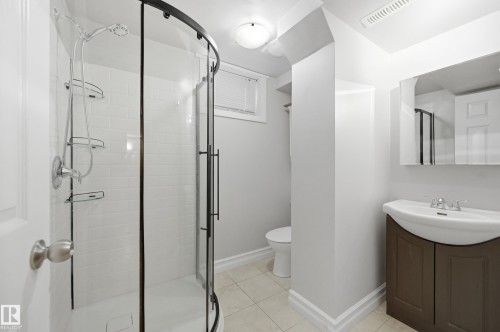 Curved glass shower enclosure with white subway tile surround - 3523 106 Street Nw, Edmonton, AB 