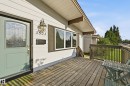 Front entry with a light blue door featuring decorative glass, a prominent house number, and an exterior wall lantern - 3523 106 Street Nw, Edmonton, AB 