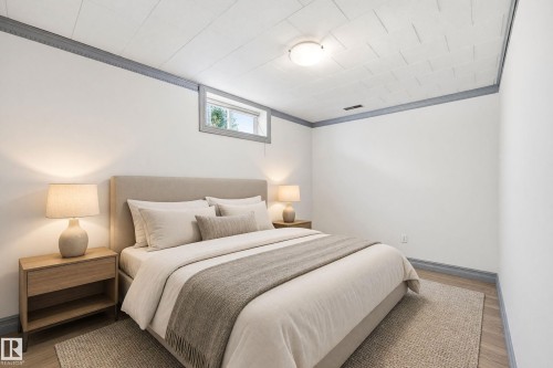 Recessed window, crown molding, wood-finish flooring, overhead lighting, and white walls - 3523 106 Street Nw, Edmonton, AB 