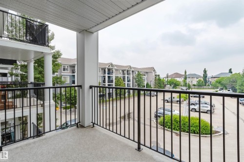 Balcony featuring a textured concrete surface and black metal railings - #304 6084 Stanton Dr Sw, Edmonton, AB - Outdoor With Balcony With Exterior