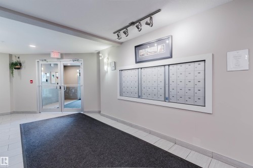 Mailbox wall with multiple individual compartments - #304 6084 Stanton Dr Sw, Edmonton, AB - Indoor Photo Showing Other Room
