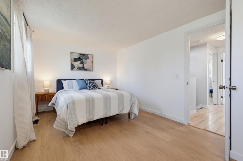 Light wood-finish flooring throughout the room - 4125 38 Street Nw, Edmonton, AB 