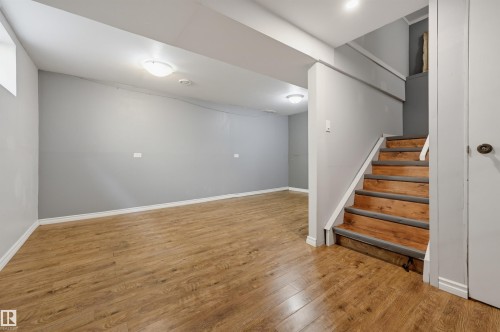 Spacious room featuring wood-finish flooring, light gray walls, and recessed lighting - 4125 38 Street Nw, Edmonton, AB 