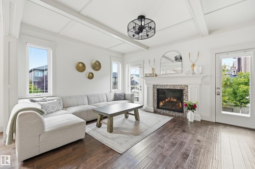 Wood-finish flooring, coffered ceiling, built-in fireplace with tile surround, white trim, and a built-in light fixture - 1961 Adamson Terrace Sw, Edmonton, AB 