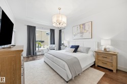 Hardwood-finish flooring with a light-toned area rug, crown molding, and a chandelier with a drum shade - 