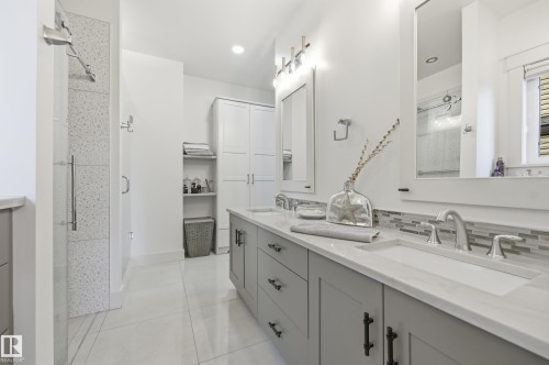 Dual vanity with undermount sinks, stone countertops, and tile backsplash - 1961 Adamson Terrace Sw, Edmonton, AB 