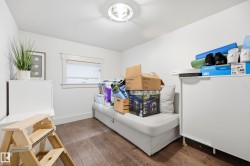 Hardwood-style flooring, white painted walls, and a ceiling-mounted light fixture - 