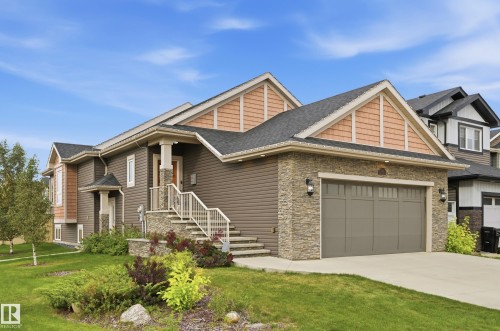 Multi-level exterior featuring stone accents, horizontal siding, and textured gable siding - 1961 Adamson Terrace Sw, Edmonton, AB 