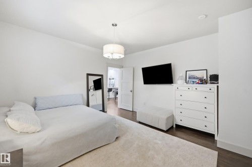 Recessed lighting and ceiling-mounted drum light fixture illuminate wood-finish flooring - 1961 Adamson Terrace Sw, Edmonton, AB 